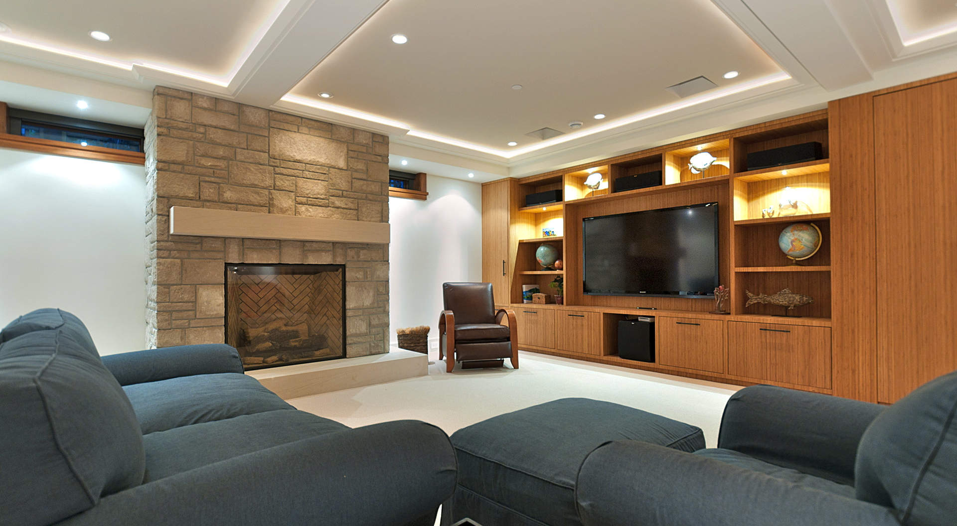 An Amazing Media Room with Fireplace & Custom Cabinetry